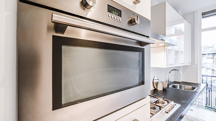 Where should the oven be placed in the kitchen?